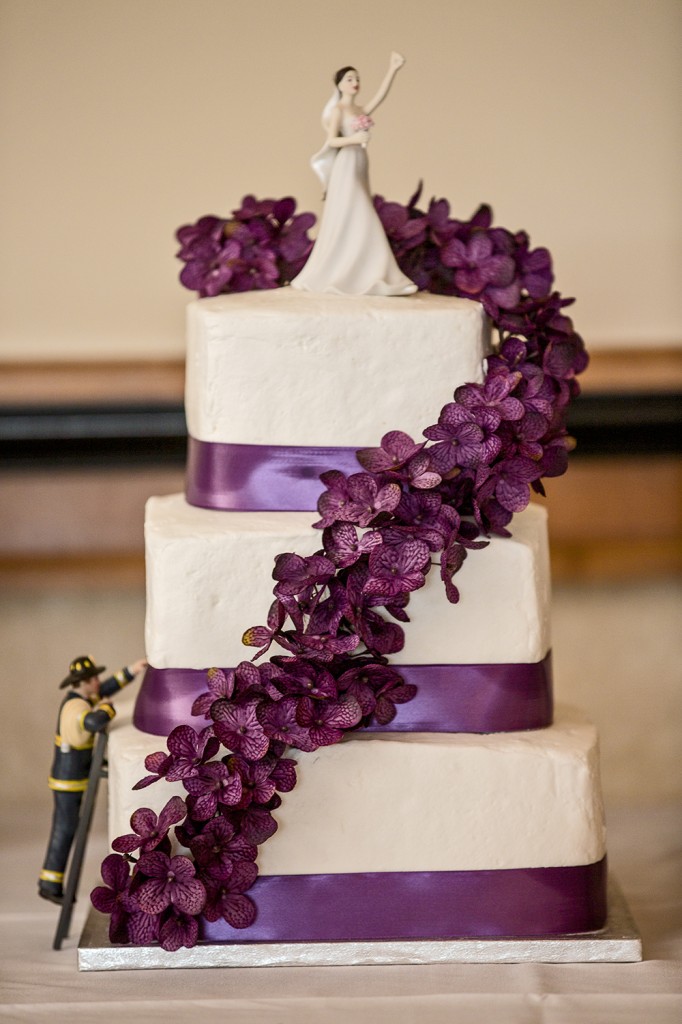 A Lake City wedding cake adorned with purple flowers.
