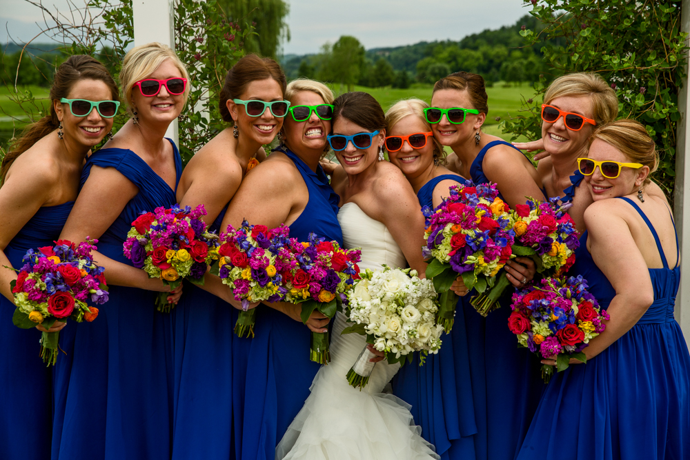 Bridesmaids donning vibrant sunglasses.