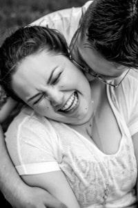 Black and white photo of a couple embracing in the rain.