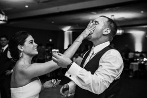 A bride and groom feeding each other at their wedding reception.