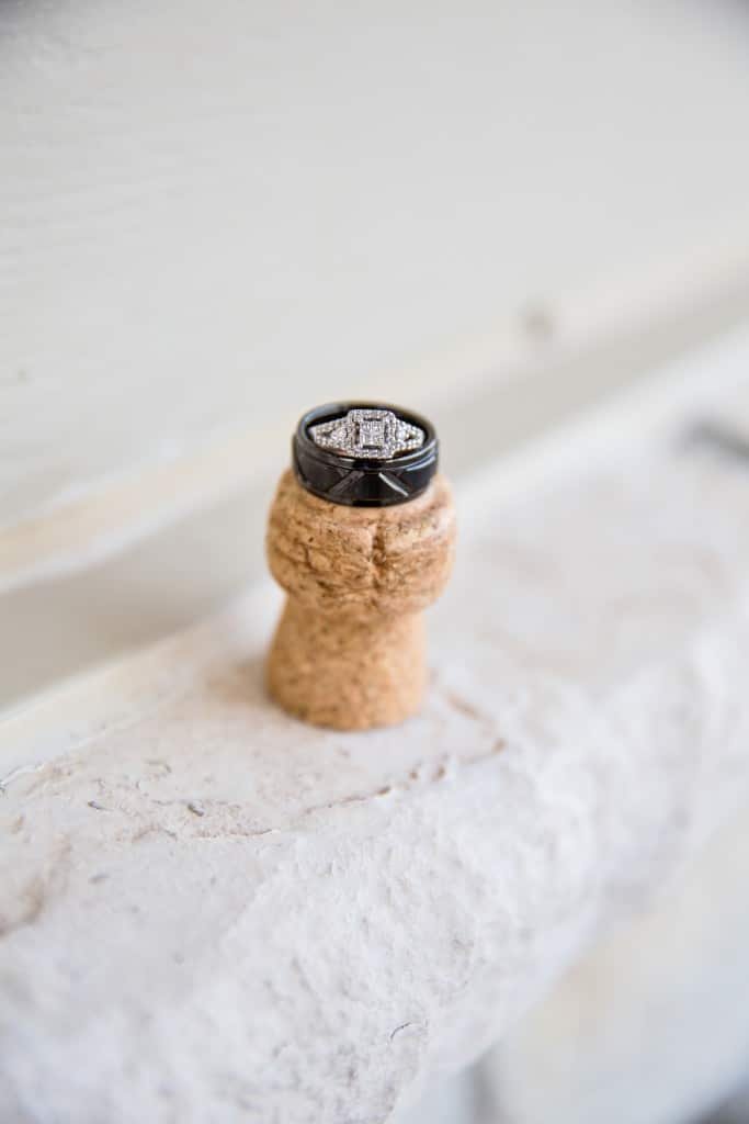 A wedding ring sits on top of a cork.