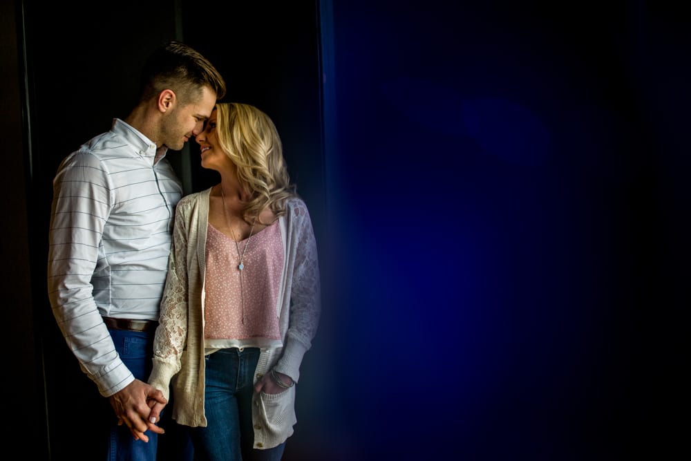 Nashville Wedding Photographer captures an embracing couple in front of a dark door.