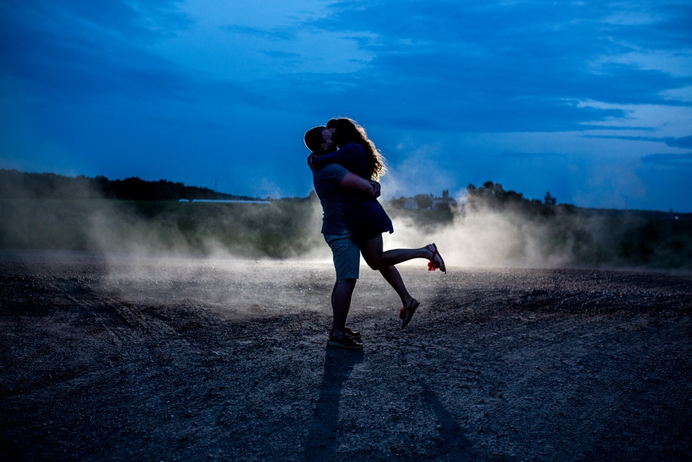 Eau Claire wedding photographer captures an intimate moment of a couple kissing in the dirt.