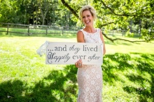 A woman holding a Rochester bridal party sign lived happily ever after.