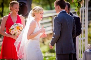 Norskedalen bride and groom exchange glances during their wedding ceremony.