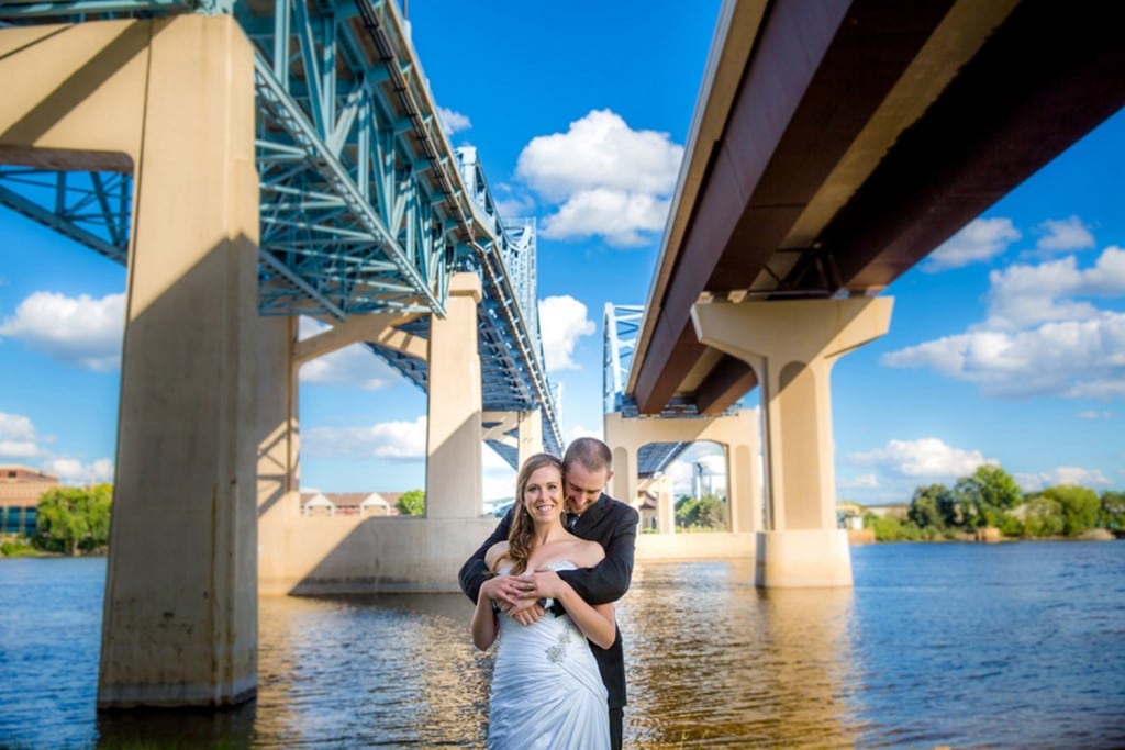 A La Crosse WI wedding couple posing under a bridge.