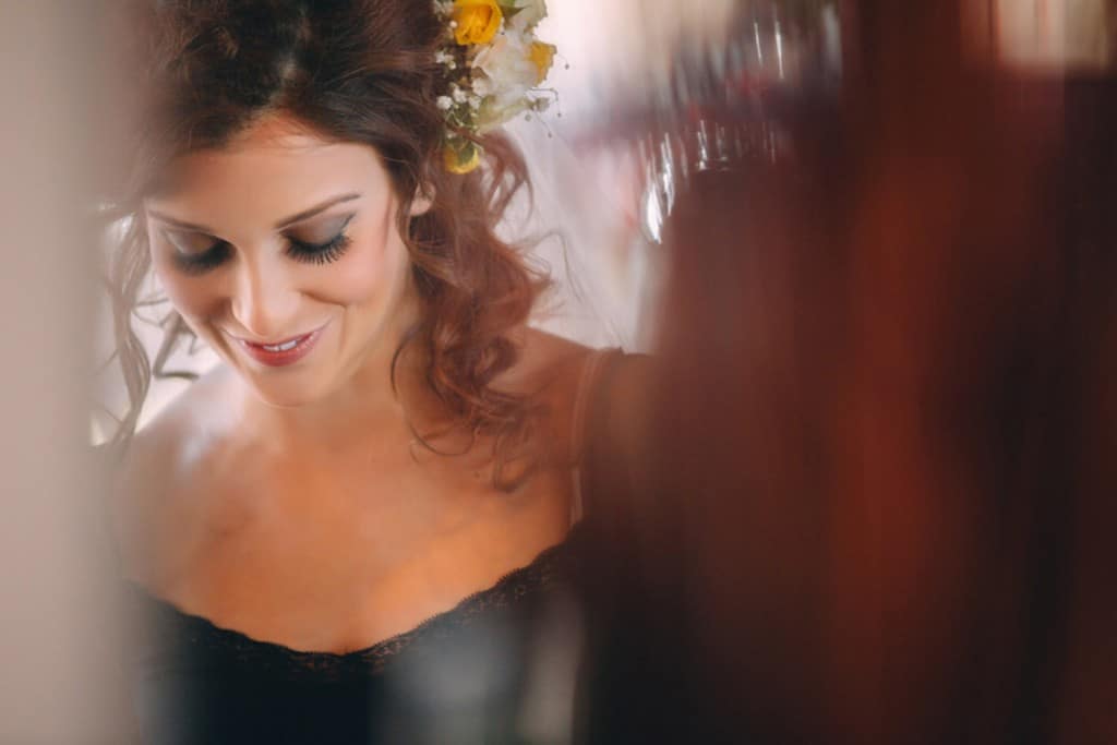 A bride in a black dress with flowers in her hair captured by an Oshkosh Wedding Photographer.