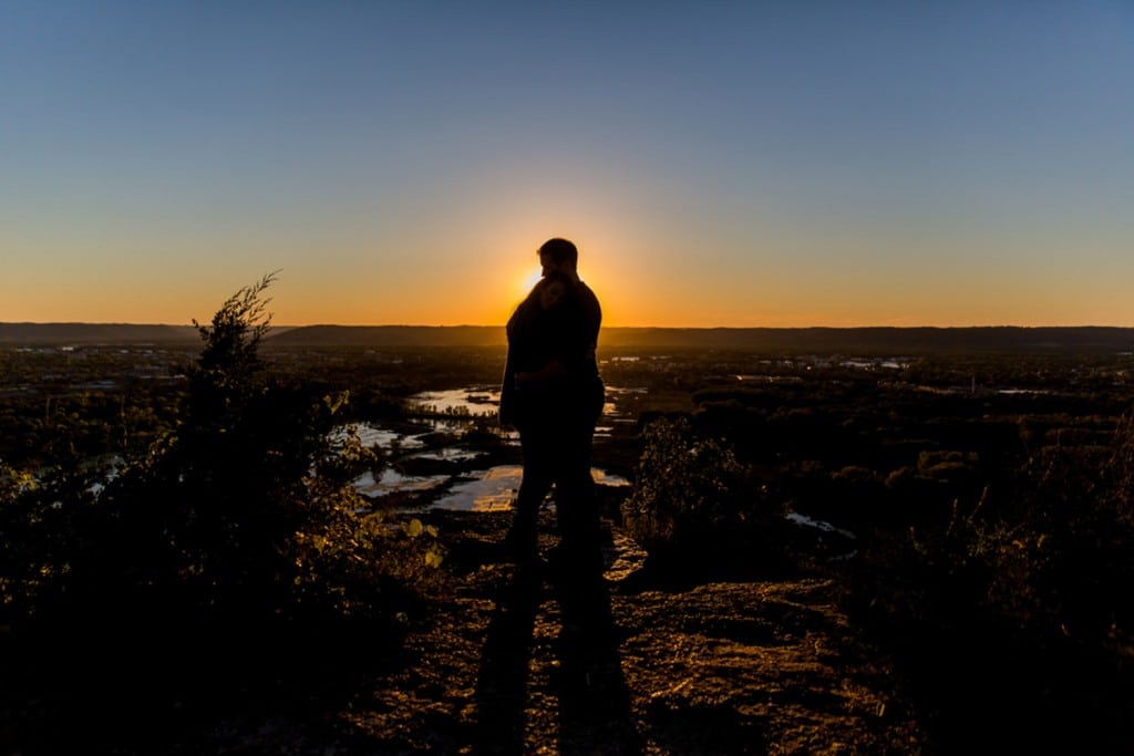 A Photographer captures a silhouette of a man standing on top of a hill at sunset in La Crosse.