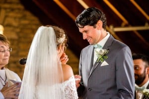 A bride and groom exchanging vows captured by a Rochester MN wedding photographer in a church.