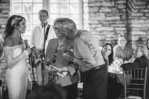 Rochester MN Wedding Photographer captures a sweet moment of a bride and groom hugging at their wedding reception.