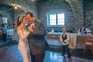 A bride and groom sharing their first dance at Mayowood Stone Barn wedding reception.
