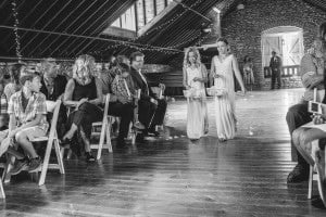 A wedding ceremony captured in a picturesque Mayowood Stone Barn, in black and white.