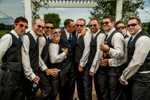A group of groomsmen posing for a beautiful wedding photo.