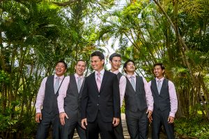 A group of groomsmen posing for a beautiful wedding photo in the jungle.