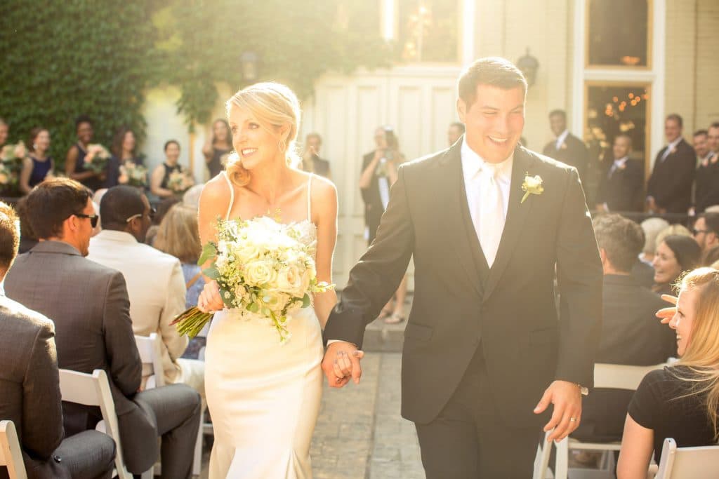 A Villa Filomena wedding featuring a bride and groom walking down the aisle at the ceremony.