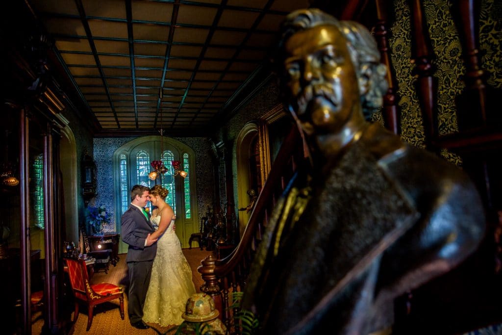 A Villa Louis wedding with a bride and groom standing in front of a statue.