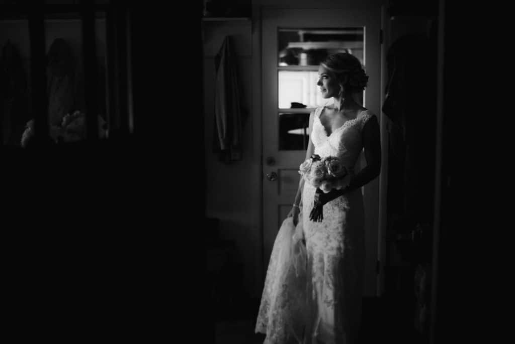 Estate wedding: A black and white photo captures a bride in a doorway.
