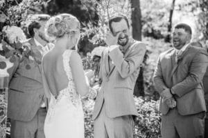 La Crosse WI Wedding Photographer captures joyful newlyweds during their ceremony.