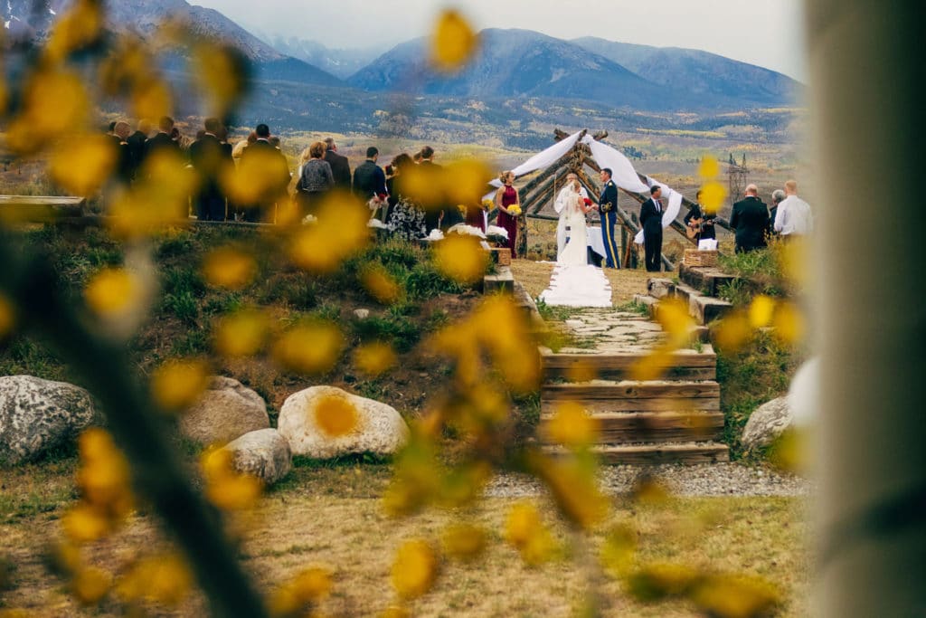 A mountainous wedding ceremony with trees as the backdrop captured by a La Crosse WI Wedding Photographer.