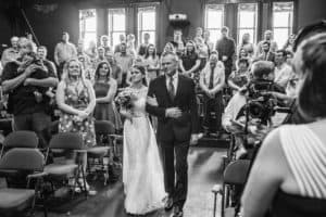 A Pump House wedding with a couple walking down the aisle.