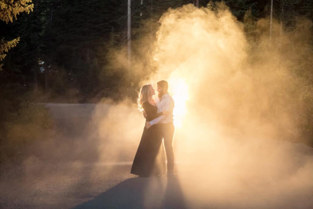 A couple kisses in front of a fire at Boreas Pass.