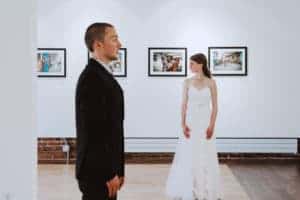 A bride and groom exchange glances during their Pump House Wedding.