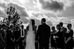 A black and white photo of a wedding ceremony.