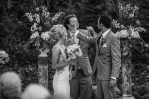 A bride and groom sharing a kiss during their wedding ceremony.