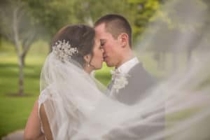 Bride and Groom under Veil at Cedar Creek Golf Club