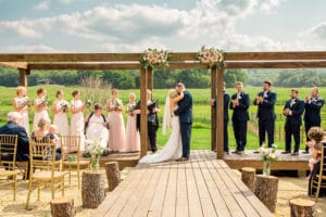 A On A Whim Barn Wedding featuring bridesmaids and groomsmen on a farm.