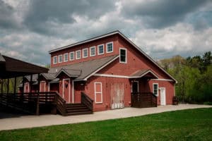 A red barn sitting on a grassy field.