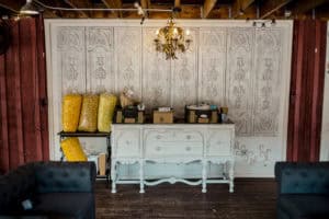 A room with couches and a dresser.
