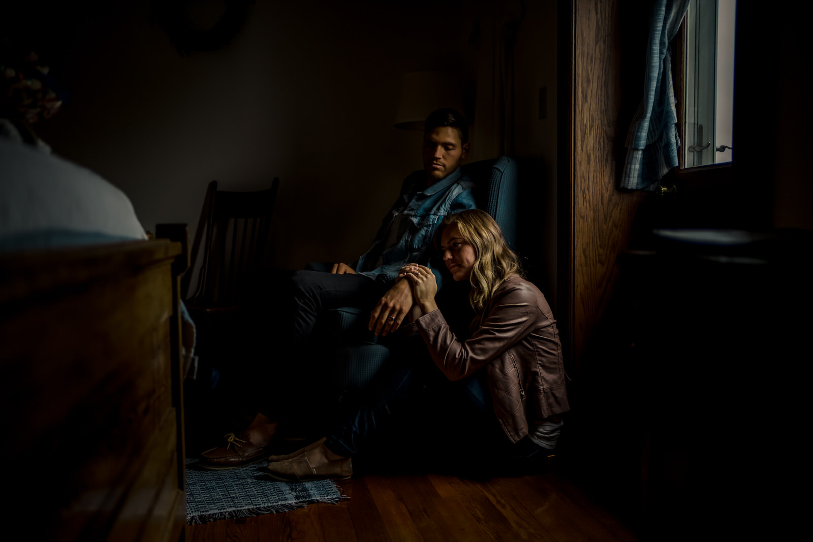 A man and woman sitting in a dark room.