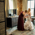 Two brides getting ready in a hotel room.