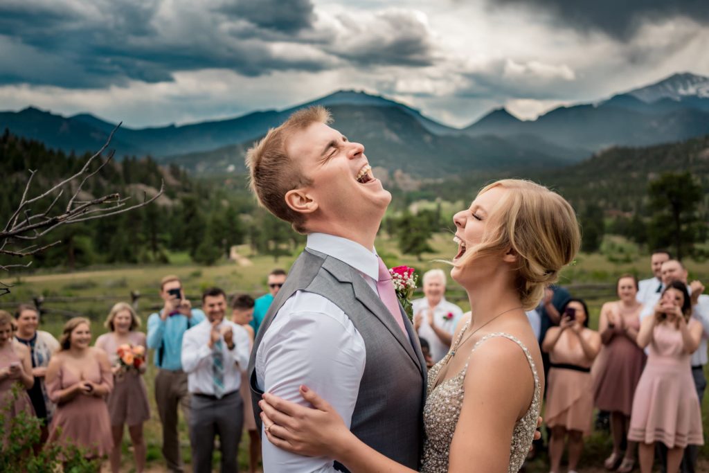 A La Crosse WI wedding photographer captures a bride and groom sharing a kiss in front of their guests.