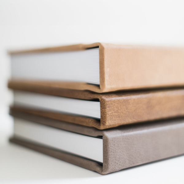 Three leather books stacked on top of each other, symbolizing a valuable investment.