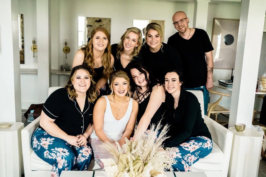 A group of women posing for a photo in a living room.