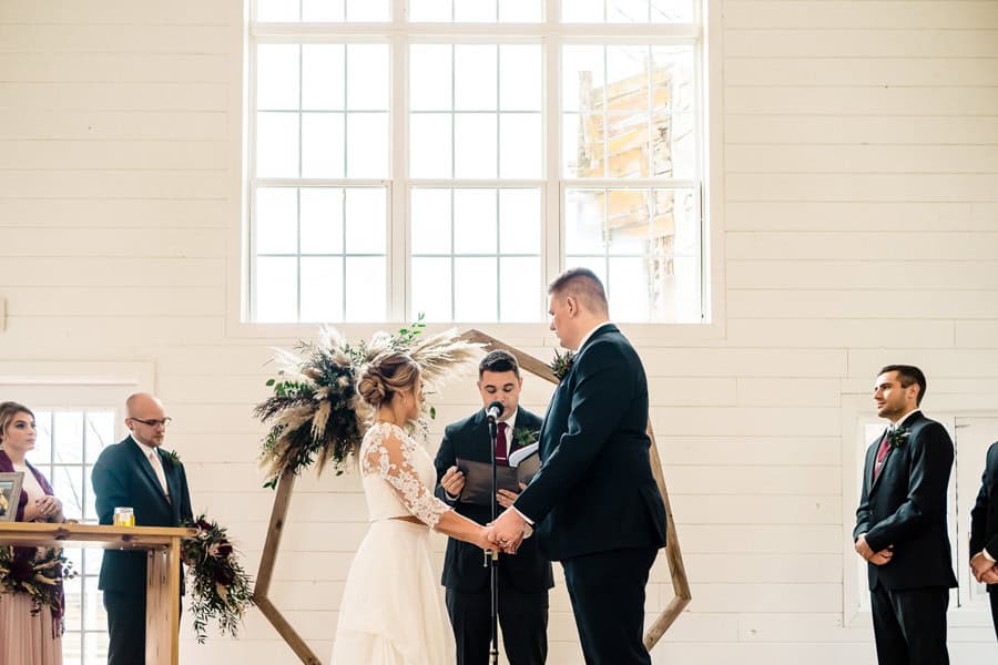 A bride and groom exchange vows during their wedding ceremony.