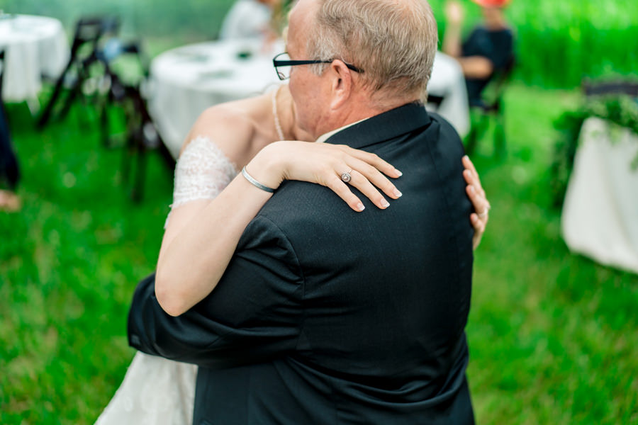 A bride hugging her father during the first dance.