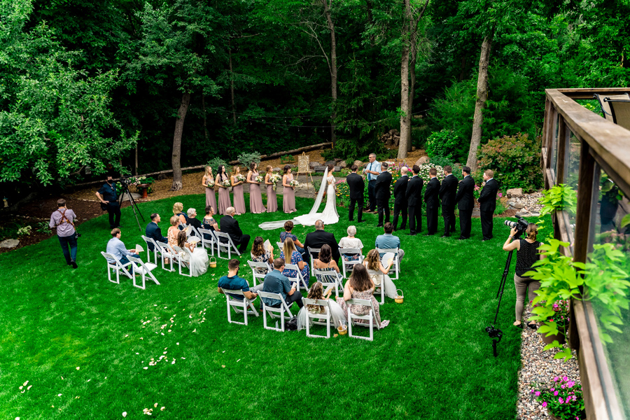 A wedding ceremony in the backyard of a house.