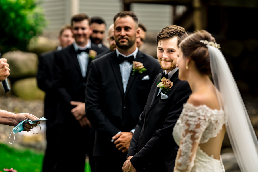 A bride and groom look at each other during a wedding ceremony.