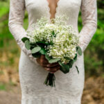 Courtyard wedding with lace dress and baby's breath bouquet.