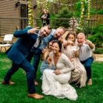 A love-filled wedding photo featuring Courtney, James, and their group of guests.