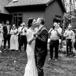 Courtney and James share their first dance in front of a love-filled backyard at their Trempleau wedding.