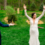 Courtney and James' love-filled backyard wedding with the bride and groom raising their arms in celebration.