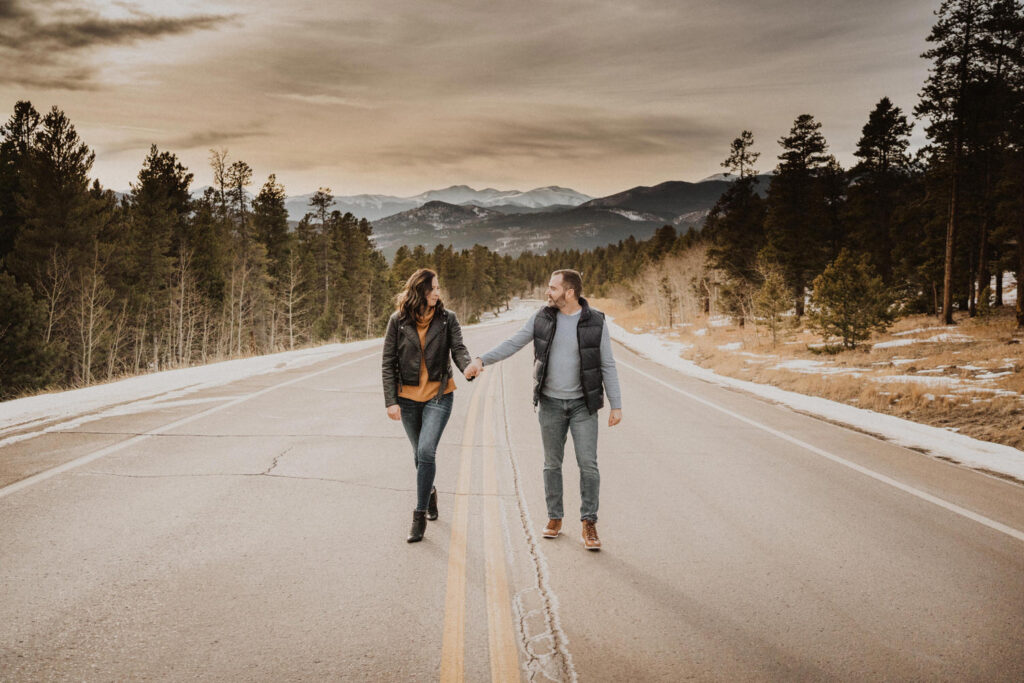 A couple walking down the road during their engagement session in colorado.