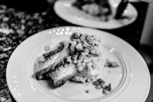 A black and white photo of a plate with food on it.