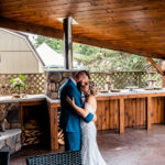 An emotional bride and groom kiss during their backyard wedding in La Crosse.
