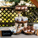 A cupcake stand featuring delicious cupcakes, perfect for an emotional backyard wedding in La Crosse.