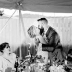 An emotional bride and groom kissing at their intimate backyard wedding in La Crosse.